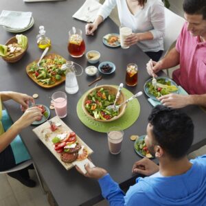 Group of people eating together at table